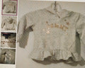 Children's sweater with 'Tommy' branding on a hanger against a white background