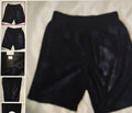 Black shorts displayed on a white surface with multiple views shown on the left.