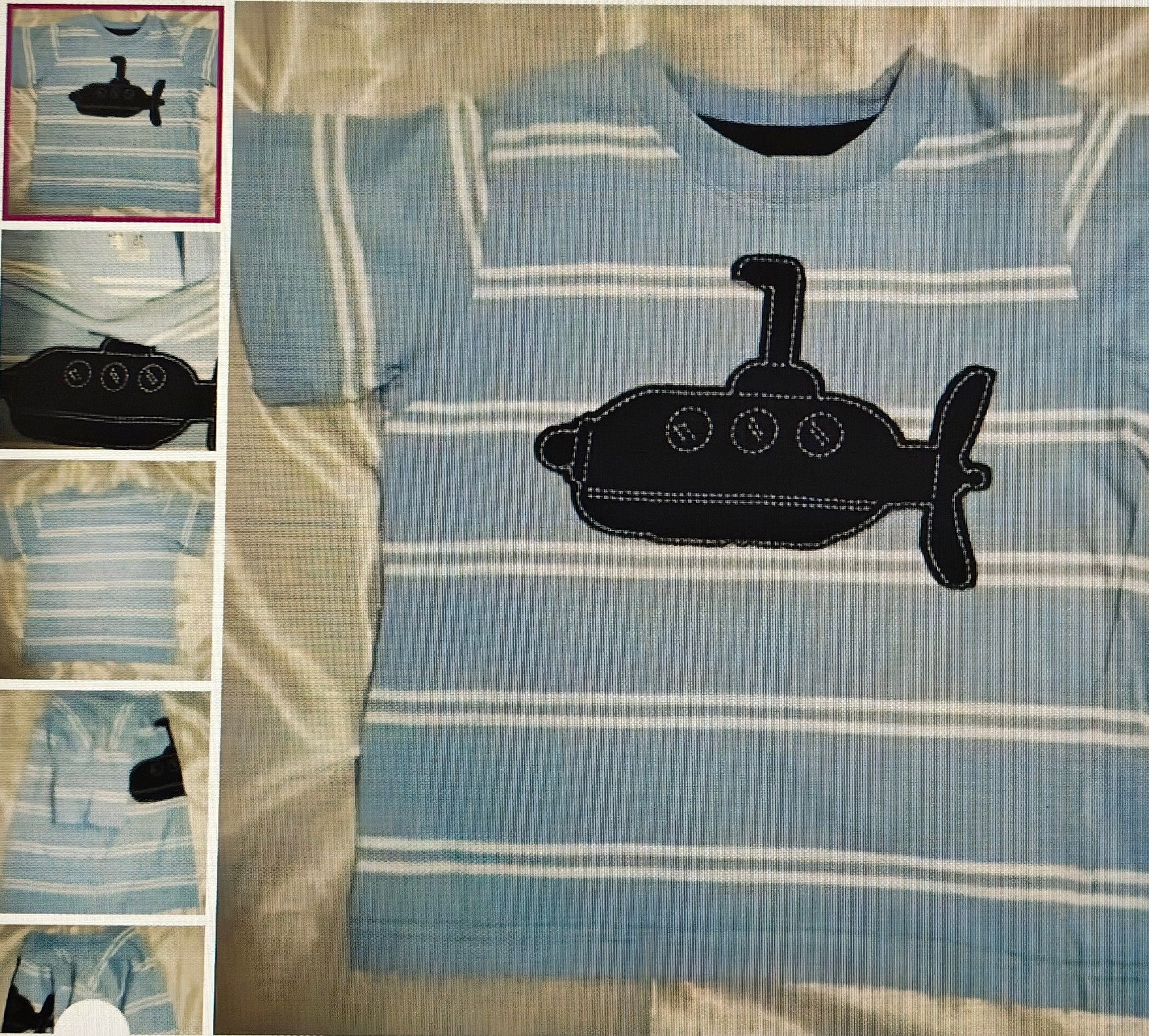 Blue striped shirt with black submarine design on a bed