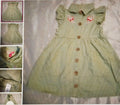 Green checkered dress with floral details on a textured surface