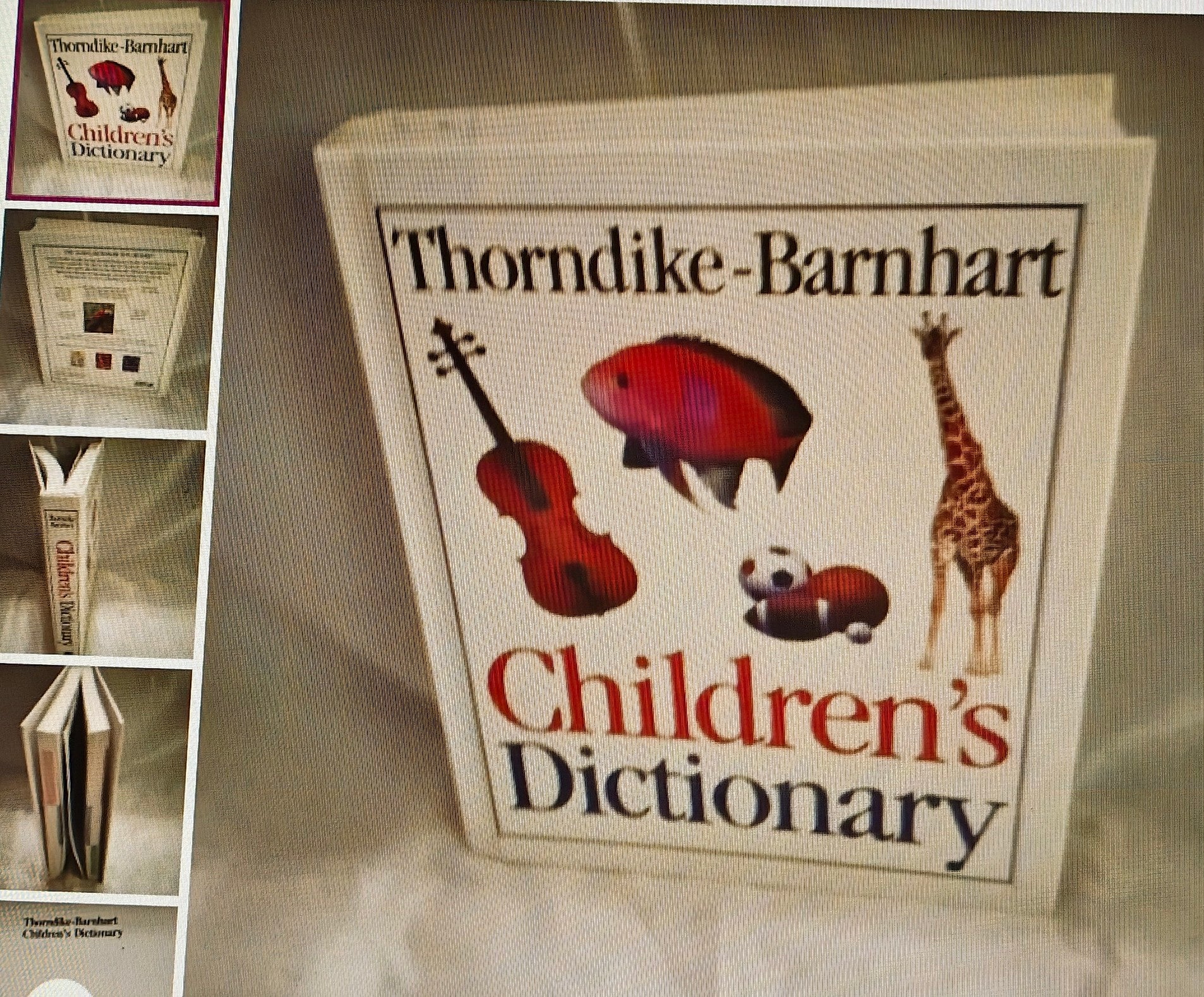 Thorndike-Barnhart Children's Dictionary with illustrations on a textured surface