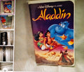 VHS tape cover of 'Aladdin' with animated characters on a textured surface