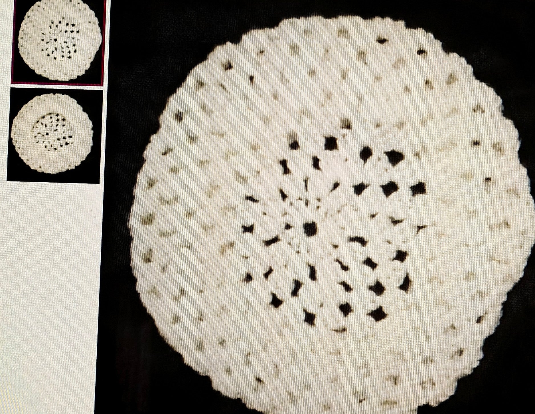White crocheted doily on a black background with smaller doilies inset on the left.