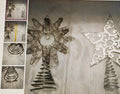 Decorative metal tree and star ornaments on a white background
