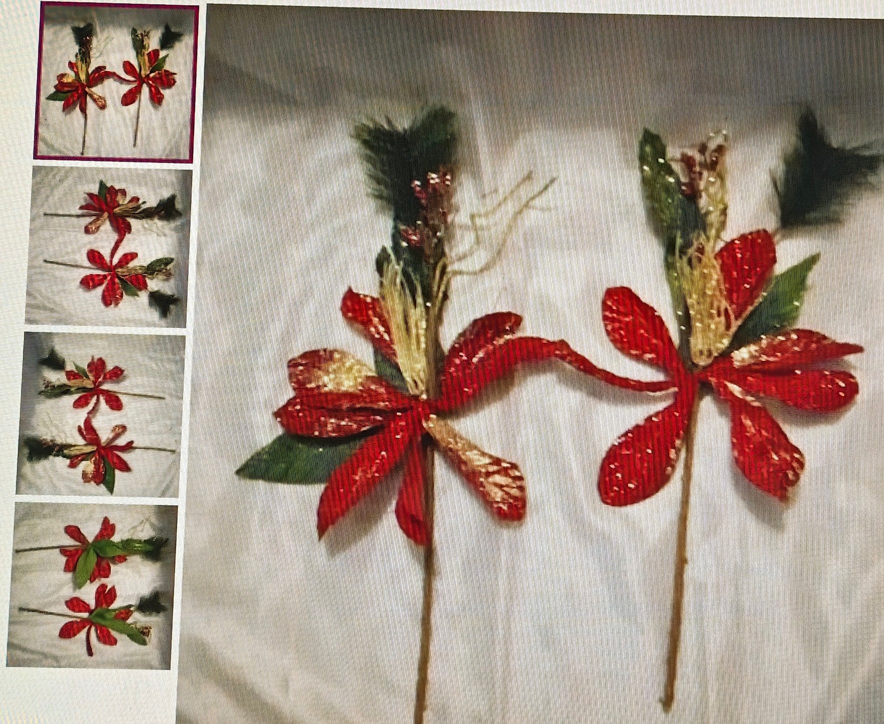 Decorative flower sticks with red flowers and green leaves on a white background.