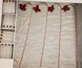 Decorative candy canes with red and green candy decorations on a textured surface.