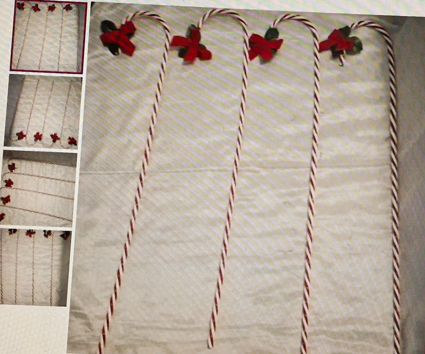 Decorative candy canes with red and green candy decorations on a textured surface.