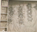 Decorative silver garland with snowflake designs on a textured surface.