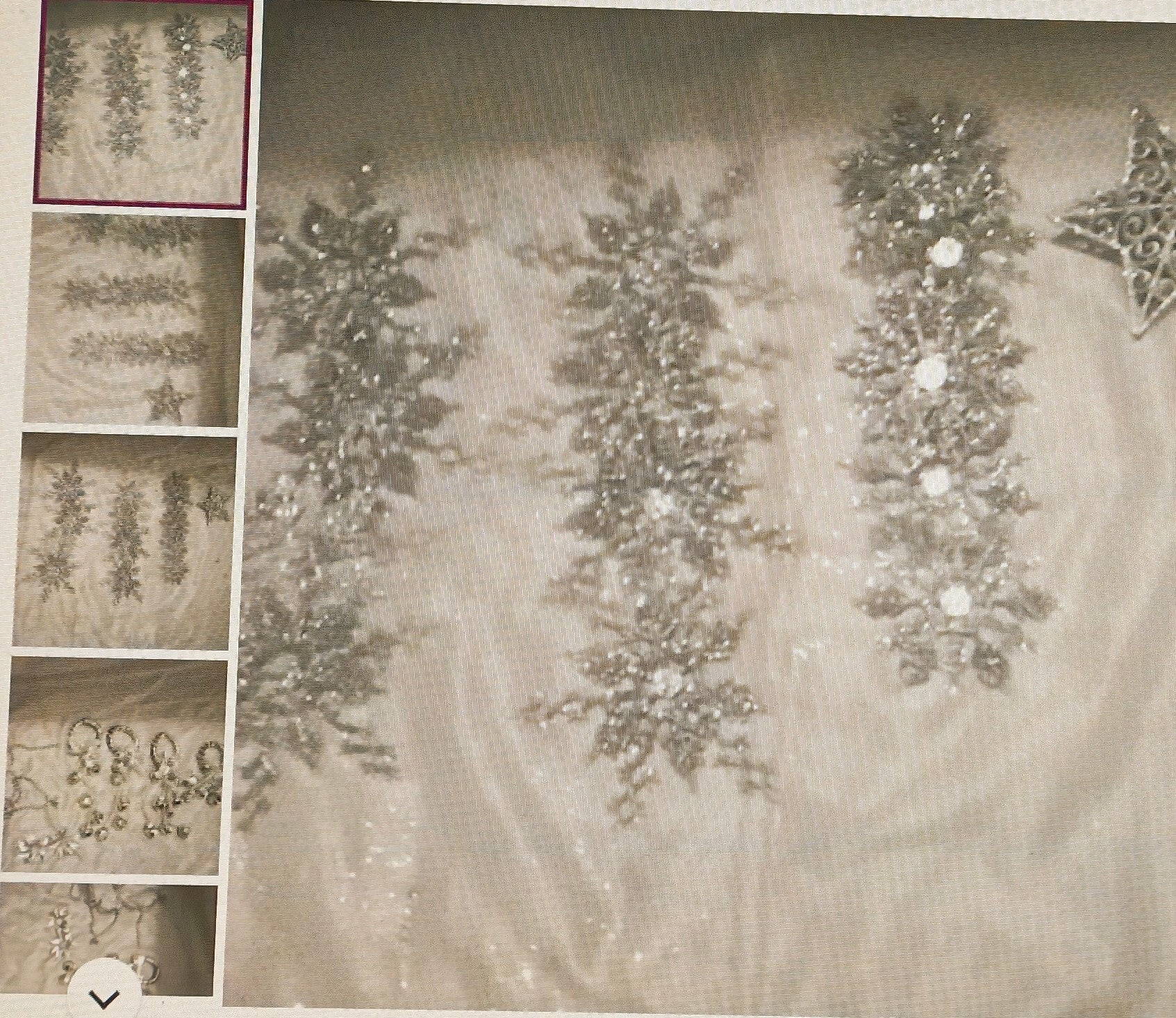 Decorative silver garland with snowflake designs on a textured surface.