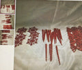 Embroidered fabric with red floral patterns on a beige background