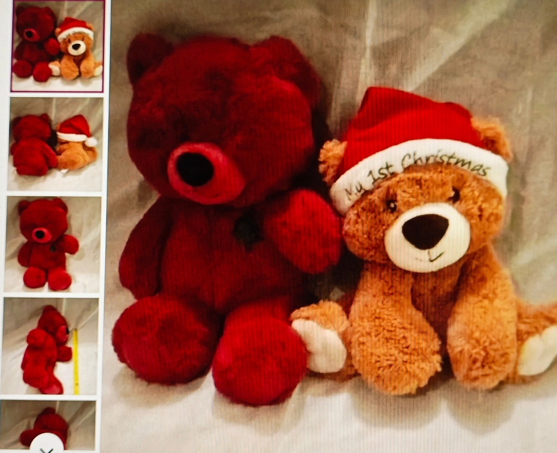 Two teddy bears, one red and one brown with a 'First Christmas' hat, on a textured surface.