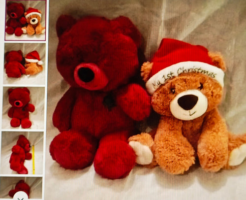 Two teddy bears, one red and one brown with a 'First Christmas' hat, on a textured surface.