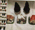 Small figurines of animals on a white surface with a product display in the corner.