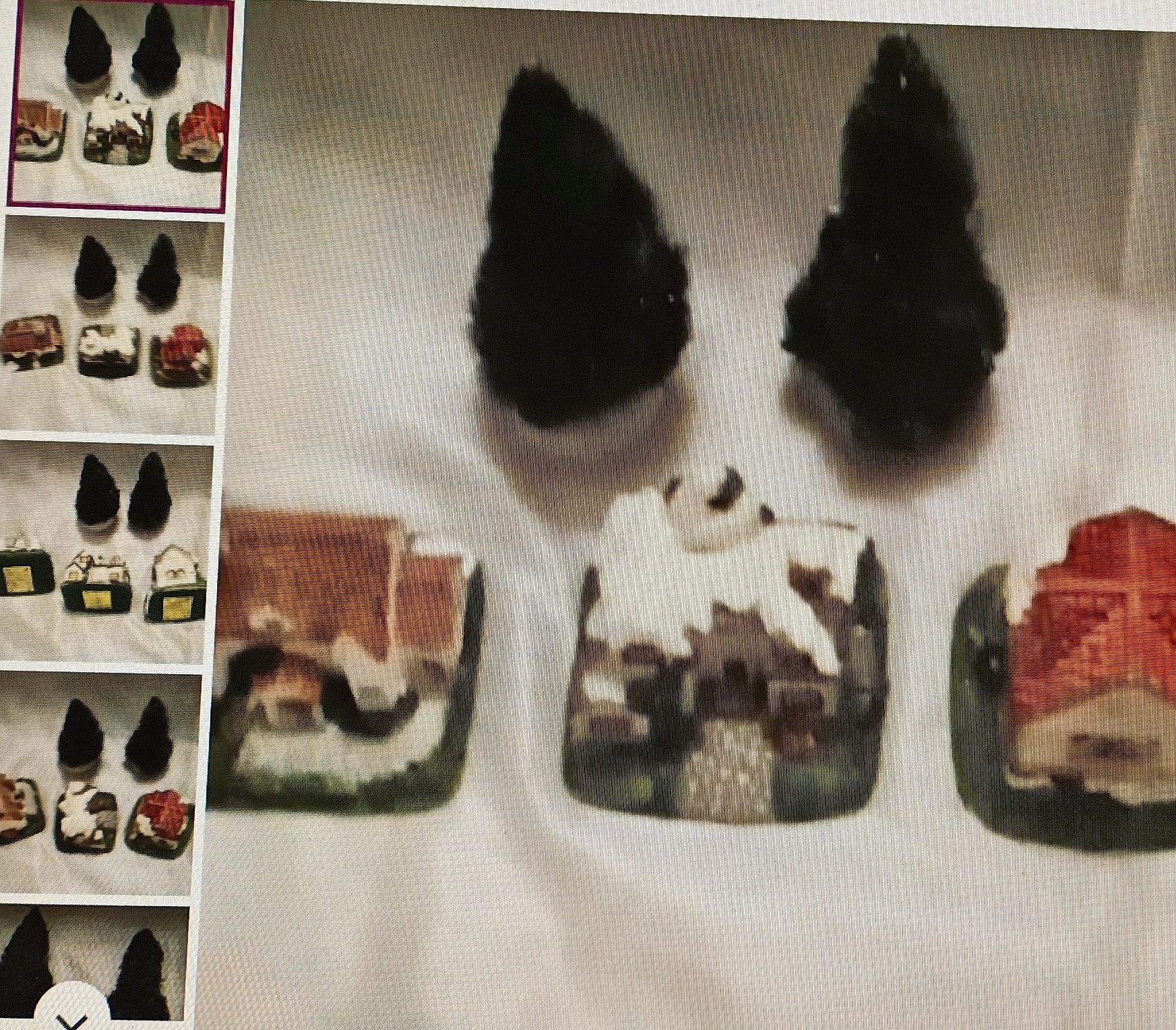 Small figurines of animals on a white surface with a product display in the corner.