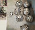 Silver decorative balls on a textured surface with close-up inset images.