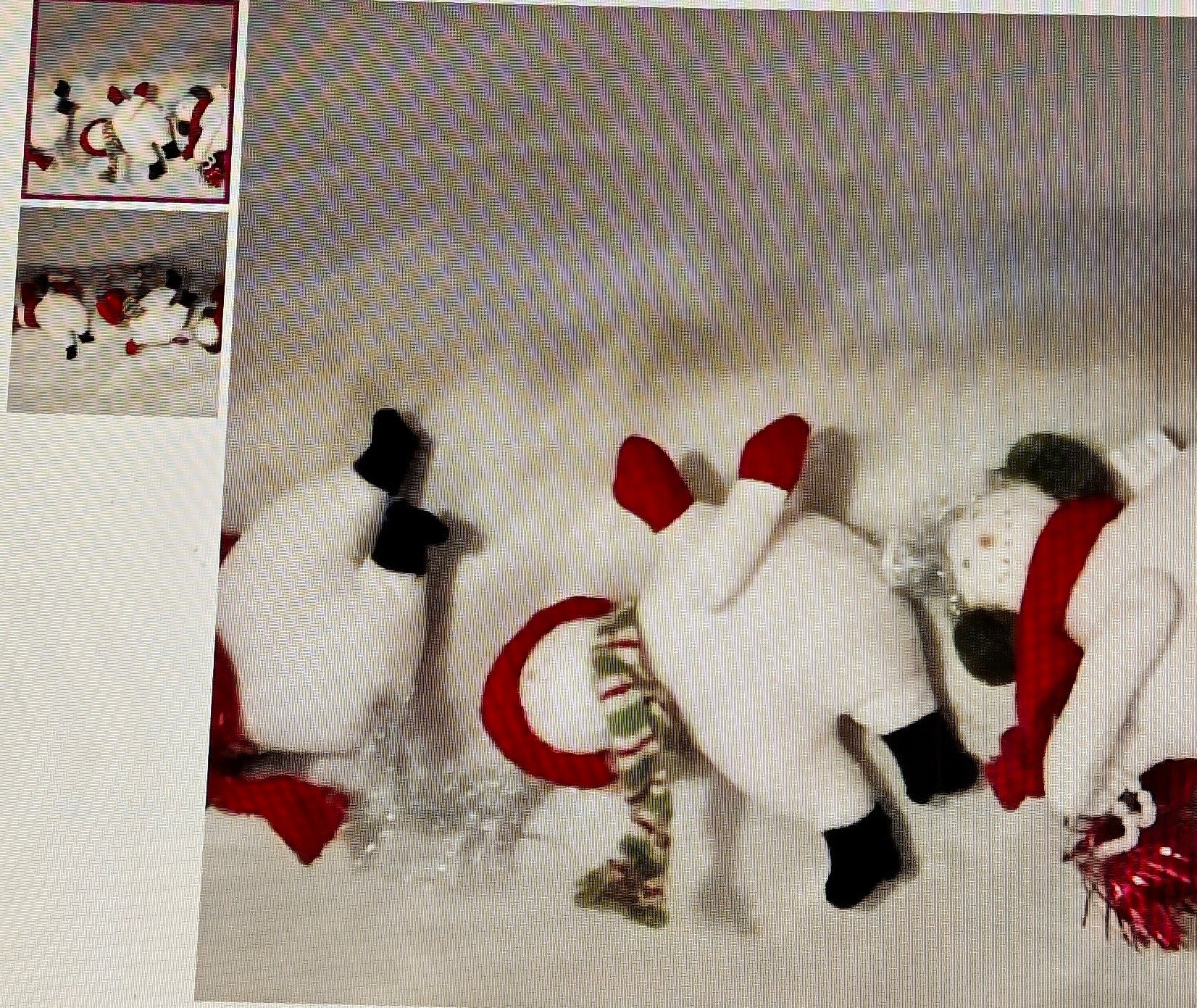 Decorative paper with snowmen and a reindeer design on a textured surface.
