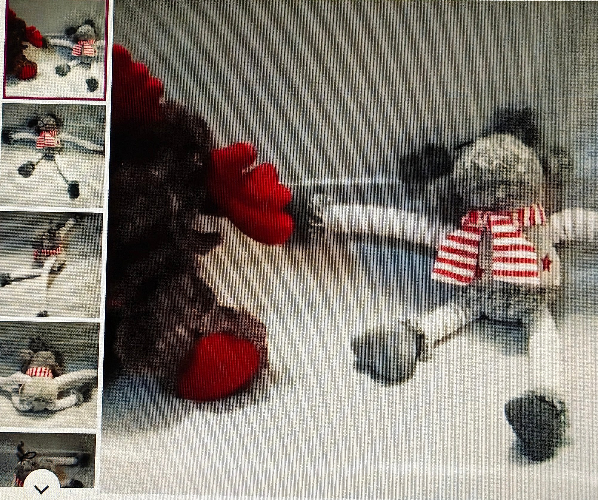 Two sock dolls, one with a red nose and the other with a striped scarf, on a textured surface.