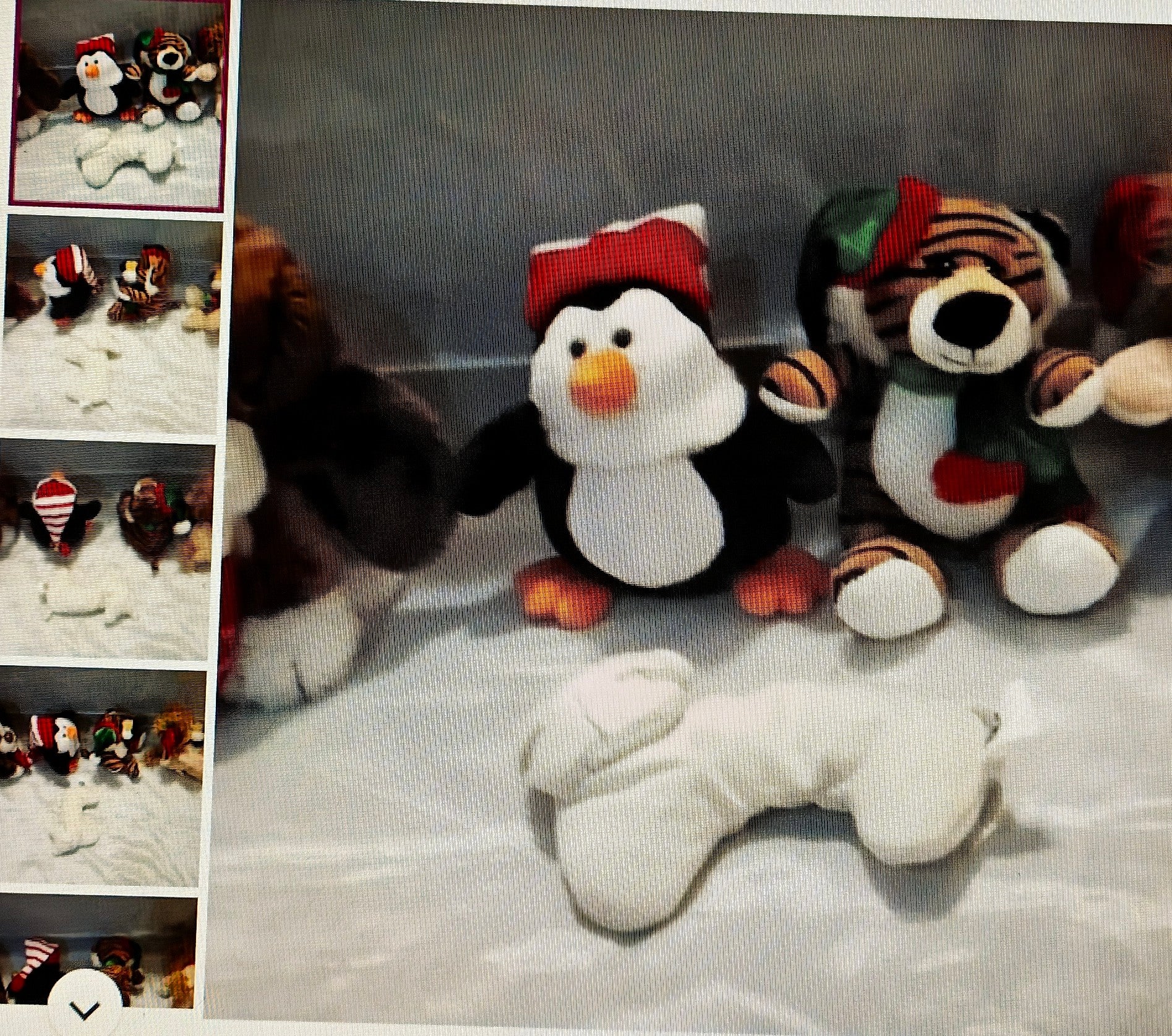 Collection of plush toys including a penguin and tiger on a textured surface.