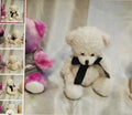 Collage of teddy bears with a focus on one wearing a black bow tie against a textured background.
