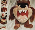 Plush toy resembling a cartoon character with a large mouth and teeth on a white background.