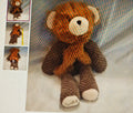 Brown teddy bear toy with a patterned background