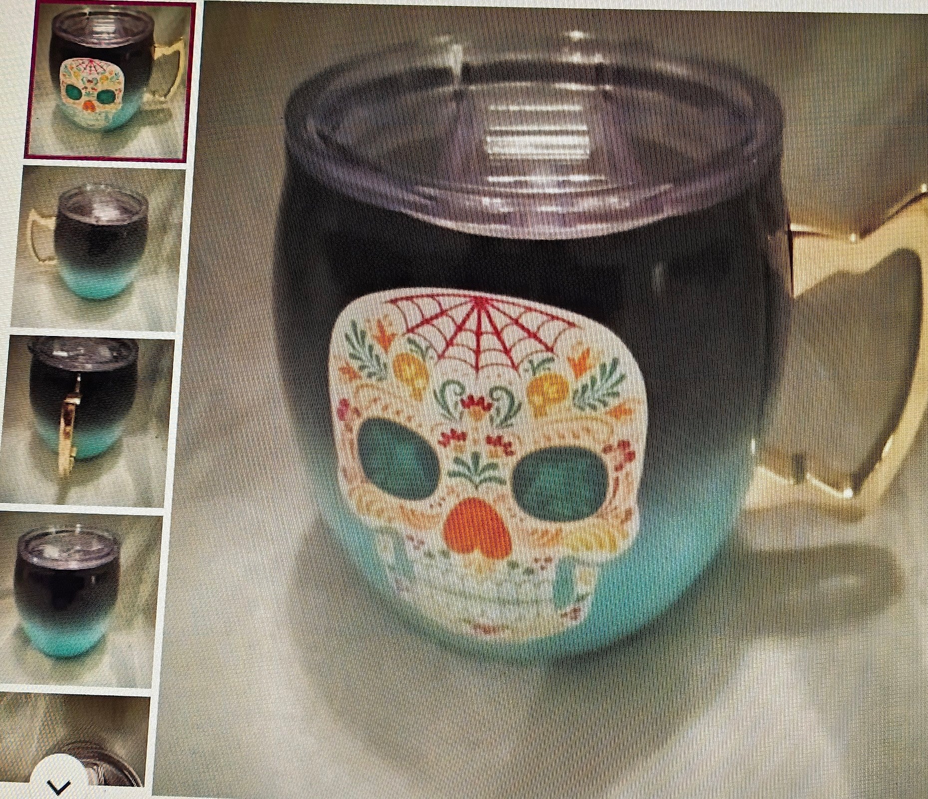 Black and blue mug with colorful skull design on a reflective surface