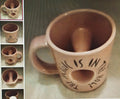 Ceramic mug with a handle and text on a textured surface