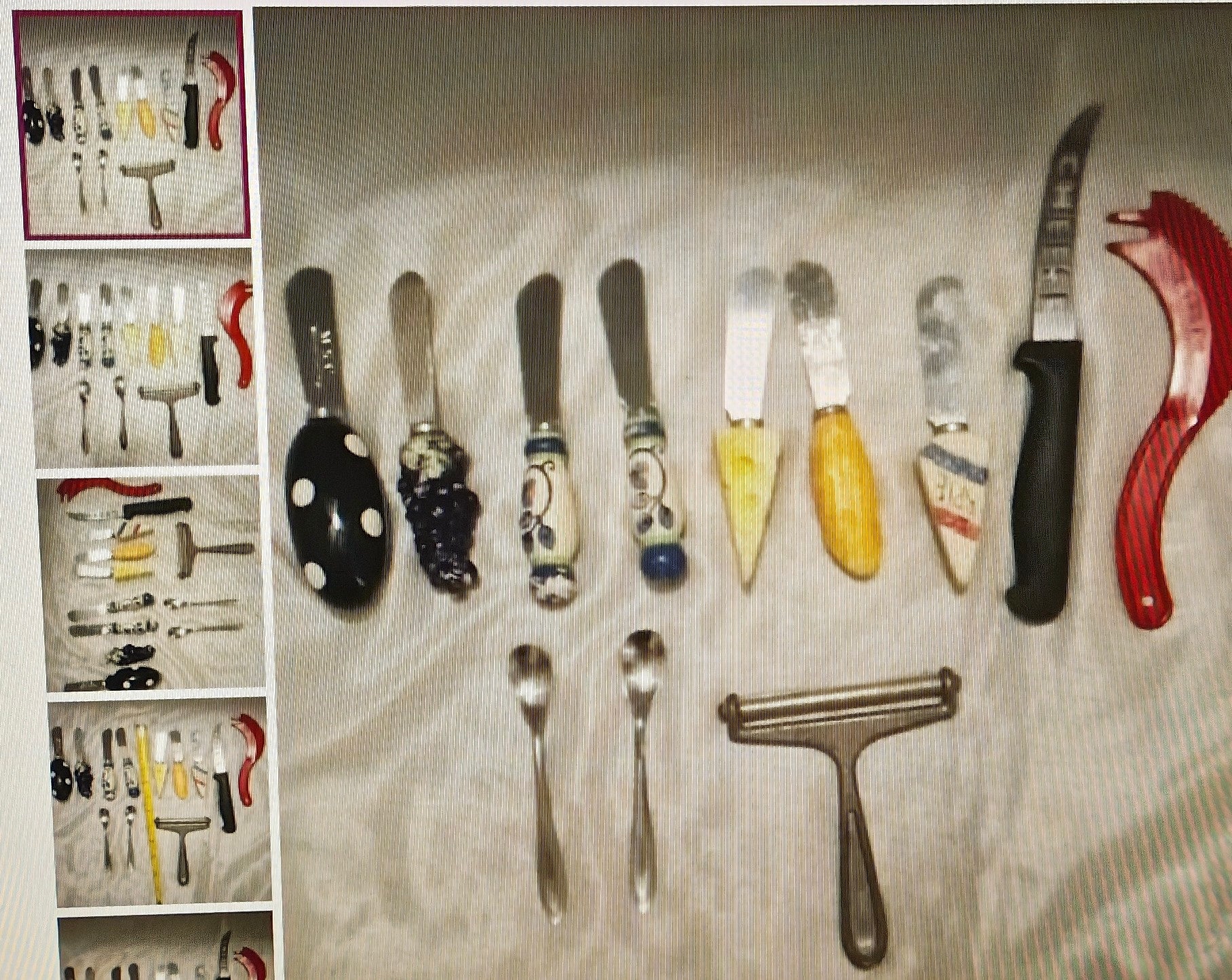 Collection of various knives and utensils on a textured surface