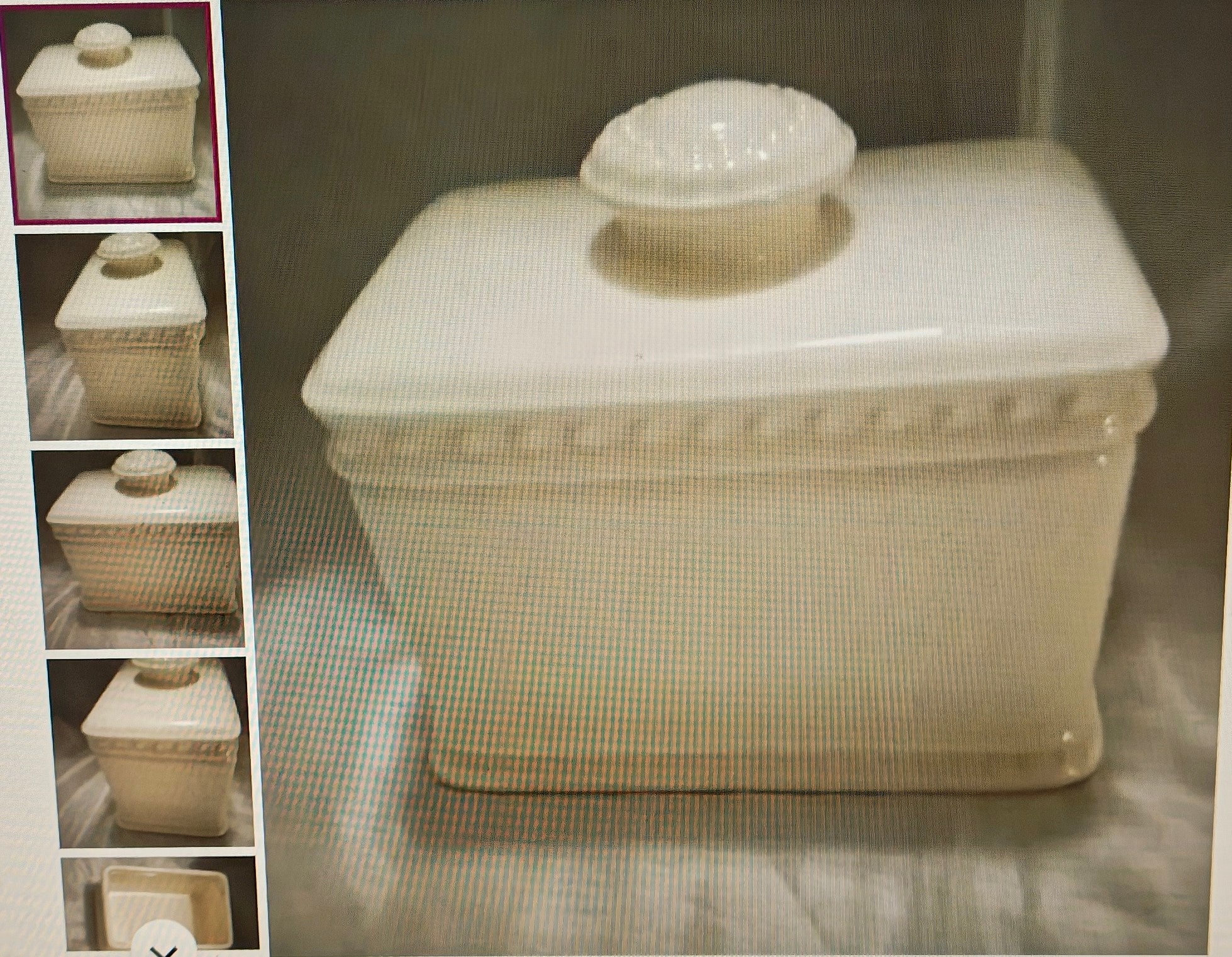 Rectangular ceramic container with lid on a reflective surface