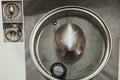 Stainless steel lid with 'Dalek Burke' branding on a metallic surface.