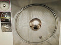 Metallic sphere on a metallic surface with a close-up inset showing its texture.