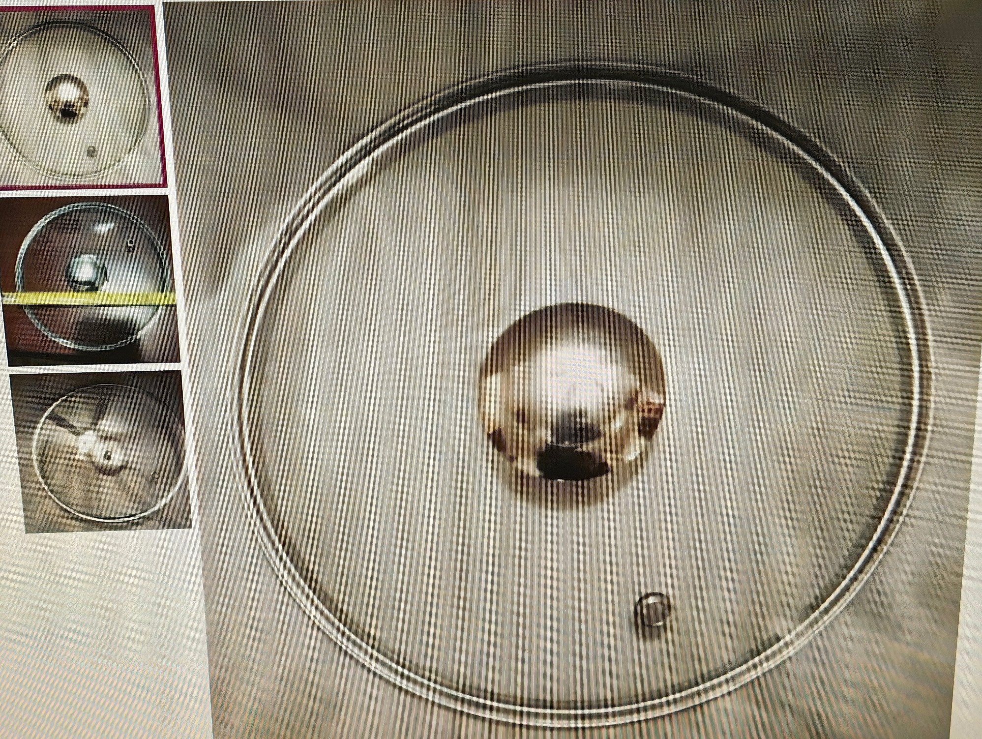 Metallic sphere on a metallic surface with a close-up inset showing its texture.