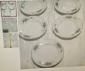Set of ceramic plates with floral patterns on a textured surface.