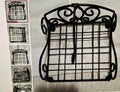 Decorative black metal grid stand with intricate designs on a textured surface.