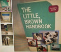 Book titled 'The Little, Brown Handbook' with multiple images of the book on a textured surface.