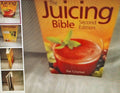 Book titled 'The Juicing Bible Second Edition' by Pat Crocker on a textured surface.
