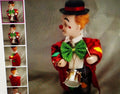 Circus clown figurine with a green bow tie and red outfit, surrounded by smaller images of the same figurine.
