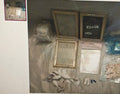 Collection of picture frames and related items on a textured surface