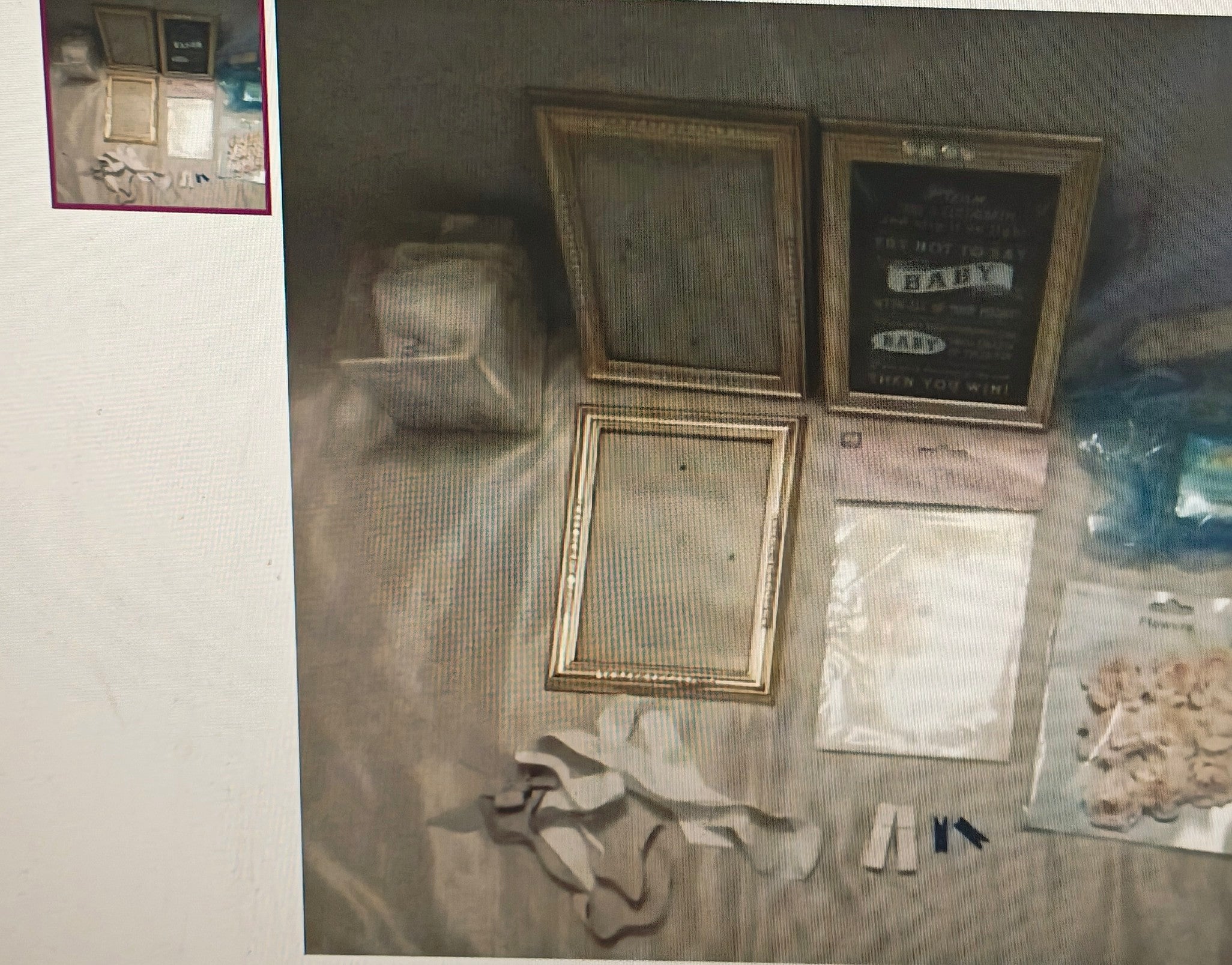 Collection of picture frames and related items on a textured surface