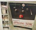 Book titled 'Beginning iPhone SDK Programming with Objective-C' by Wei-Meng Lee on a table.