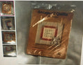 Packaged antiques quilt with 'Home Sweet Home' text on a reflective surface