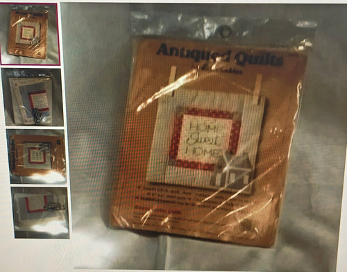 Packaged antiques quilt with 'Home Sweet Home' text on a reflective surface