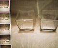 Set of clear glass containers on a textured surface