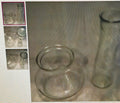 Clear glass bowls and a vase on a textured surface with inset images.