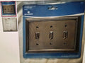 Metallic switch plate with Brainerd logo on a blue protective sheet