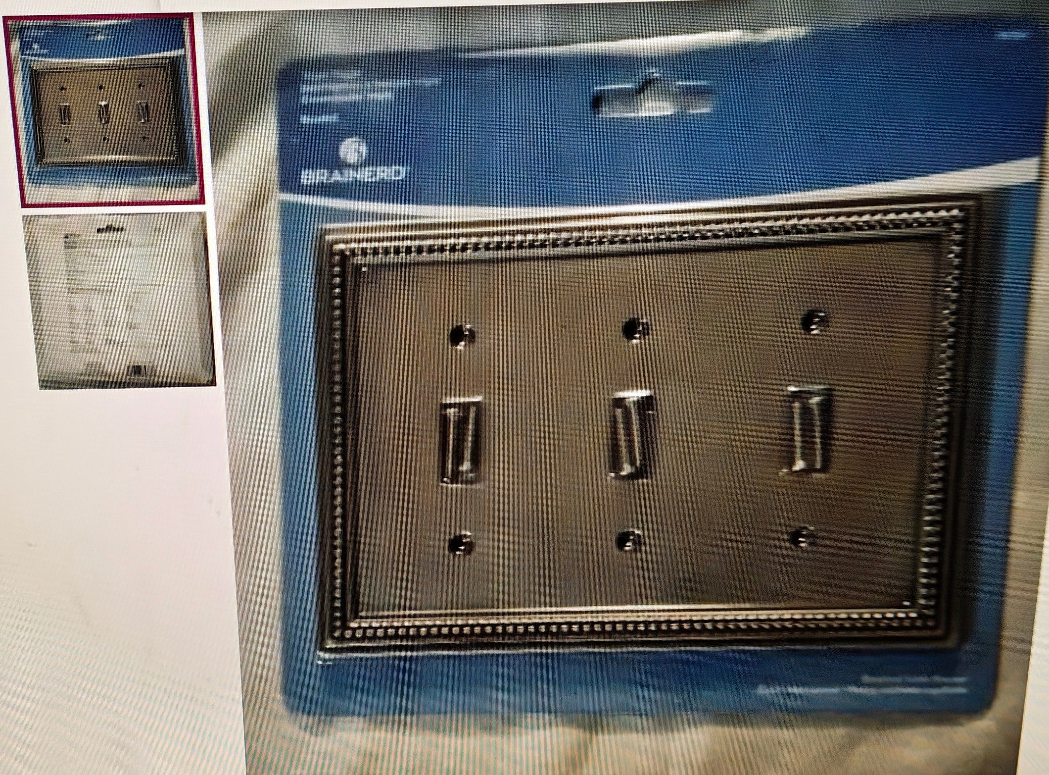 Metallic switch plate with Brainerd logo on a blue protective sheet