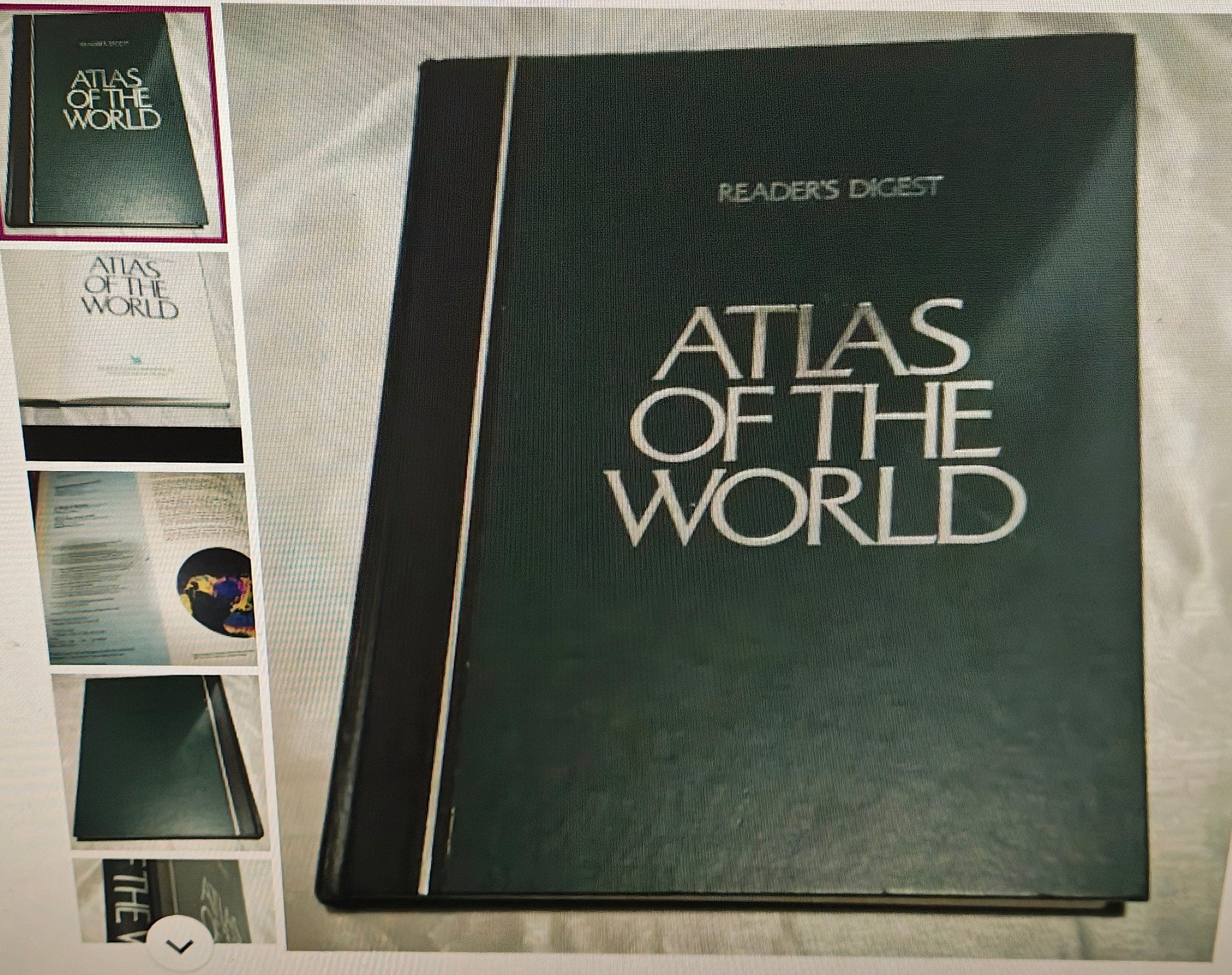 Reader's Digest Atlas of the World on a textured surface with smaller atlas images in the corner.