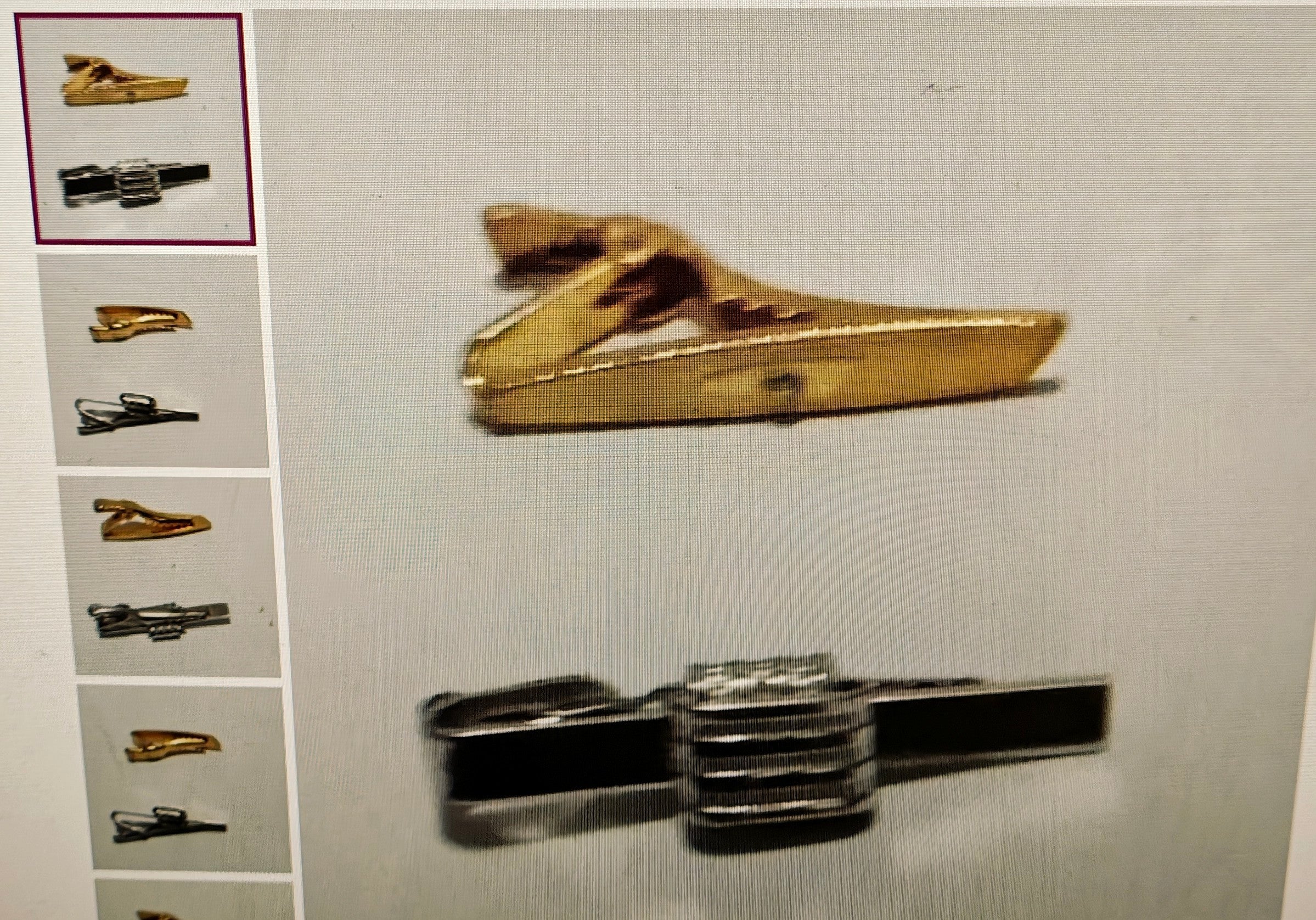 Collection of gold and silver tie clips on a light gray background