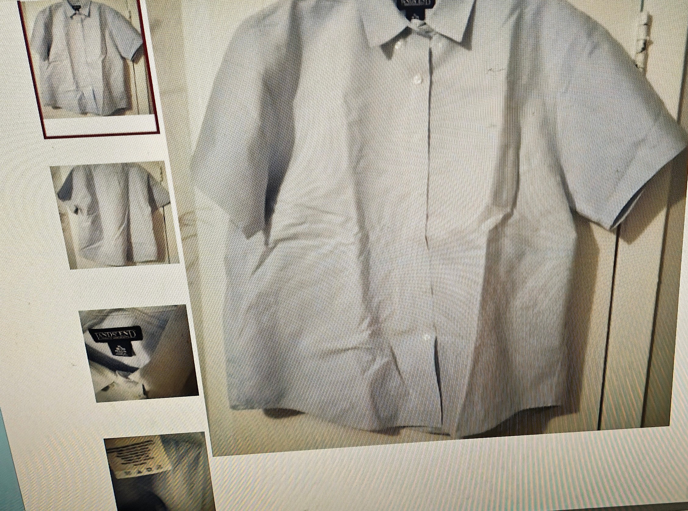 Light gray checkered shirt on a hanger with a small mirror reflection.
