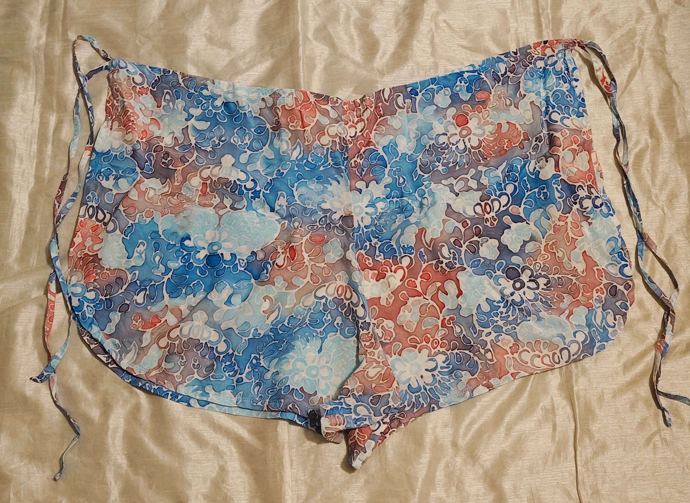 Floral-patterned apron on a beige surface